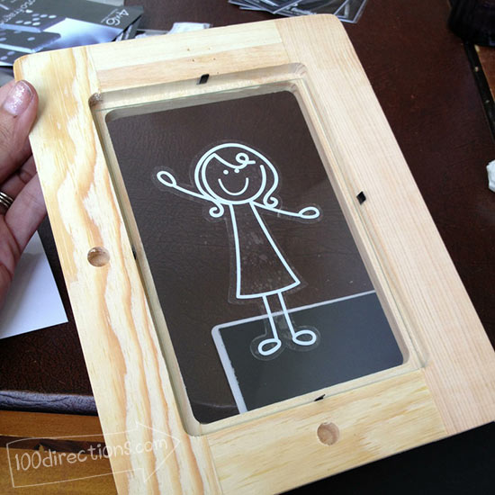 Place decal on inside of glass and back with black paper
