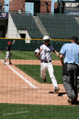 My oldest crossing home plate at the pro stadium