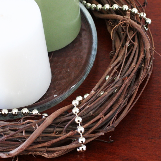 Wrap a strand of gold beads to dress up a grapevine wreath