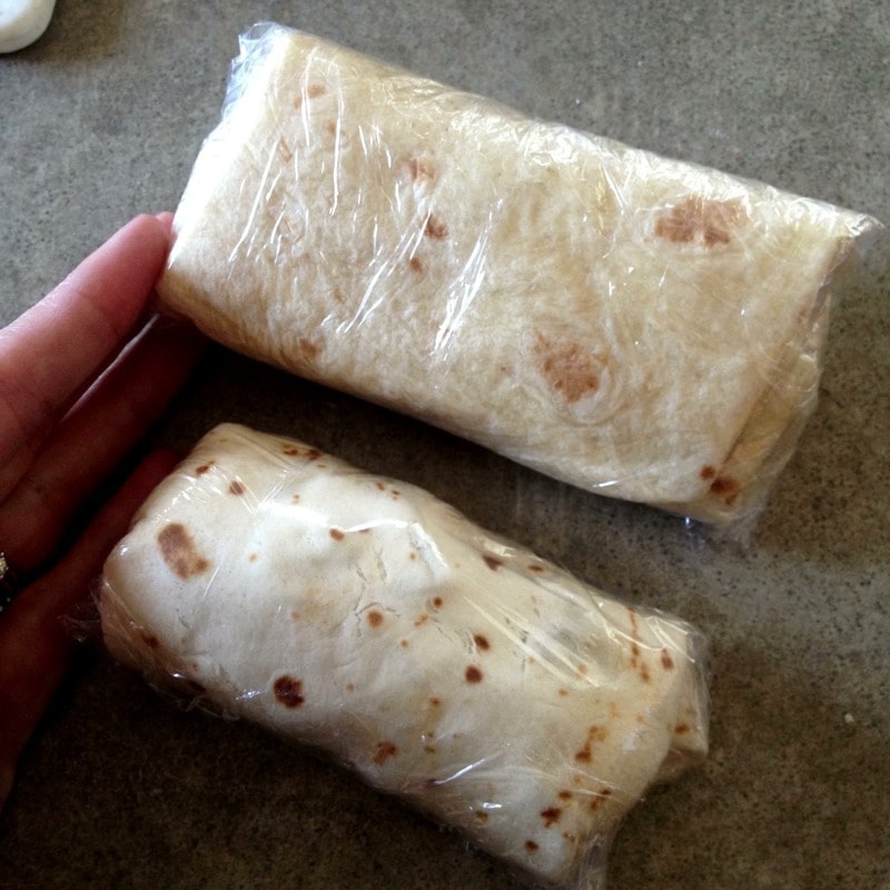 Wrap breakfast burritos with plastic wrap