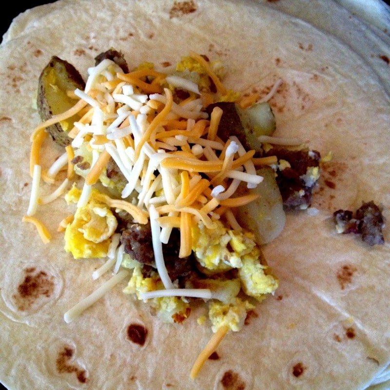 Fill tortilla with cooked ingredients to make easy breakfast burritos