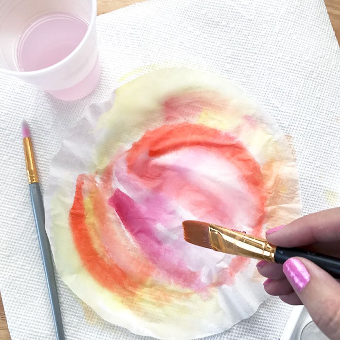Apply layers of paint to the coffee filters