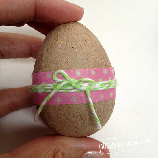 Tie twine around paper mache egg