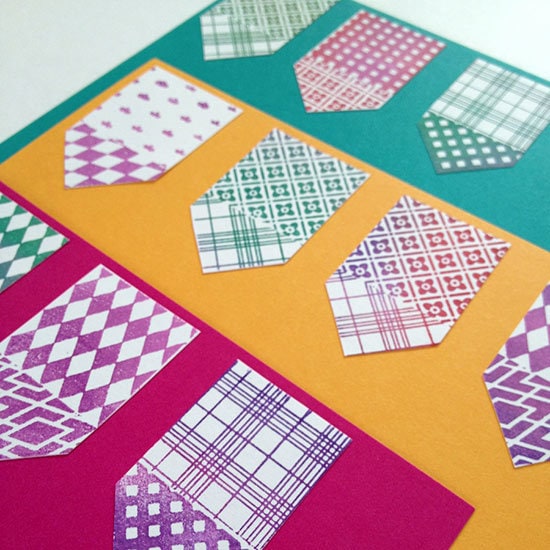 Adhere stamped cutouts to colored paper