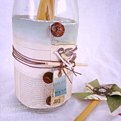 Decorate bottle with paper, buttons and twine