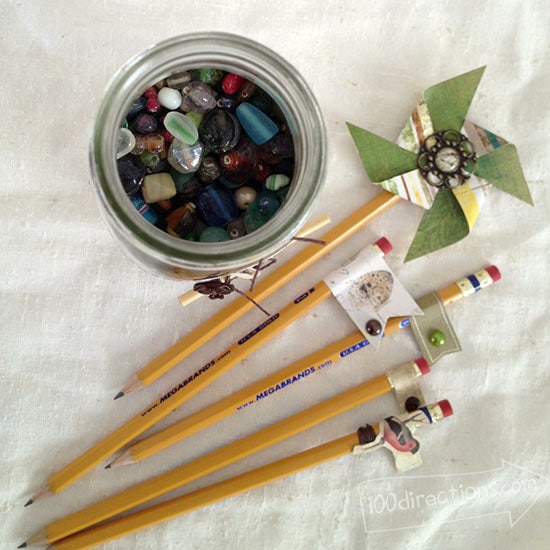 Glass beads in the jar and decorated pencil ends