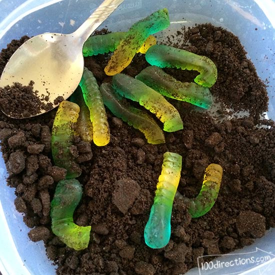 Stir gummy worms in Oreo crumbs