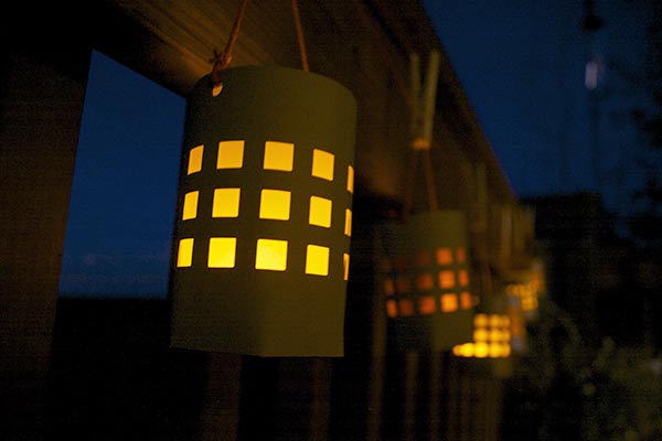 Hang the lanterns on a railing or set on a table