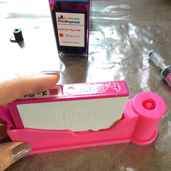 Place your empty ink cartridge in the cartridge holder