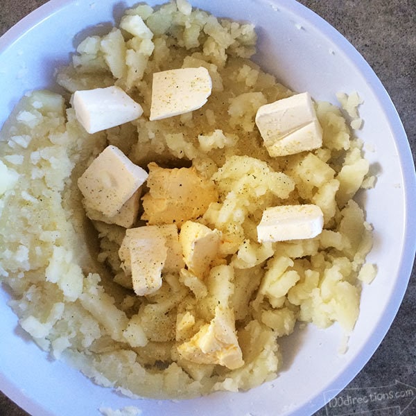 Cheesy Garlic Mashed Potatoes - mix in butter, cream cheese and seasoning