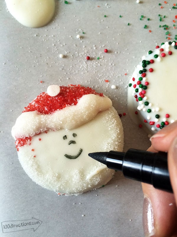 Use a candy pen to draw Santa's face