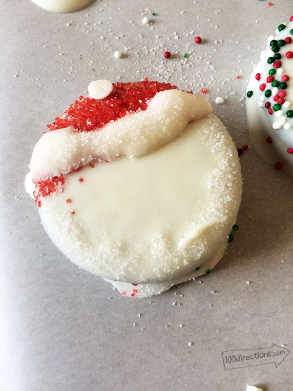 Sprinkle sugar on wet melted chocolate to make beard and hat for Santa