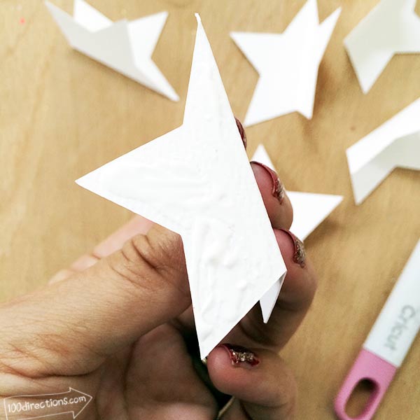 Apply glue to one side of folded star