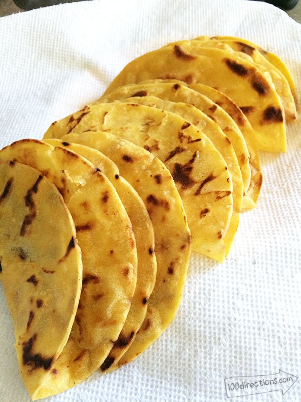 Finished taco shells cooling on a paper towel