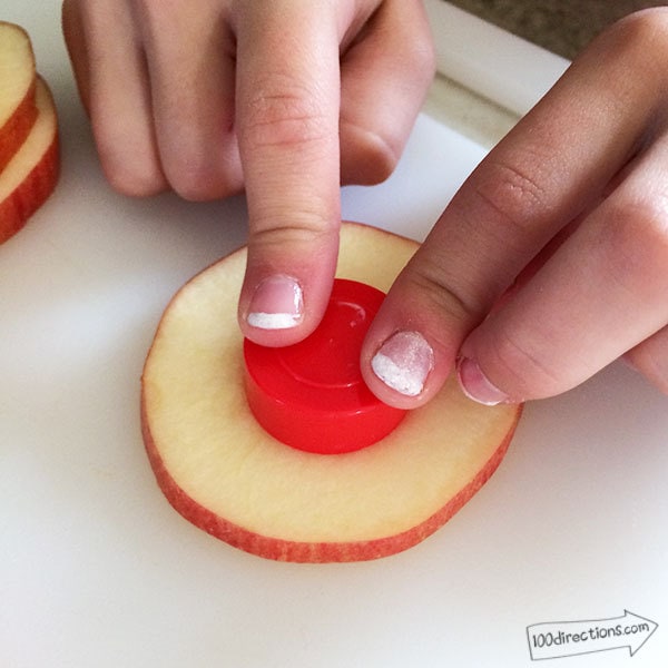 Cut a circle out of the center of the apple slice