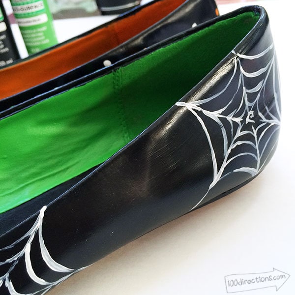Paint a spider web or two on one side of one of the shoes
