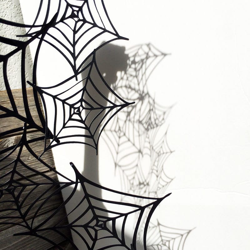 Playing in the shadows with a paper spiderweb 