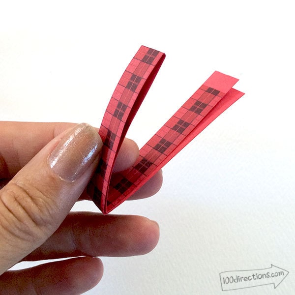 Fold paper strip in half, twice