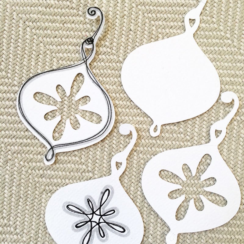 Create a layered ornament with different cut and drawn pieces