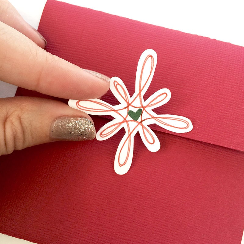 Use the drawn snowflake art as a sticker for the back of the envelope