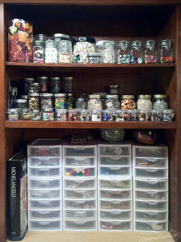 Craft supplies organized with jars and drawers