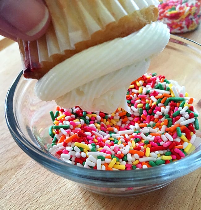 Dip frosted cupcake into bowl of sprinkles