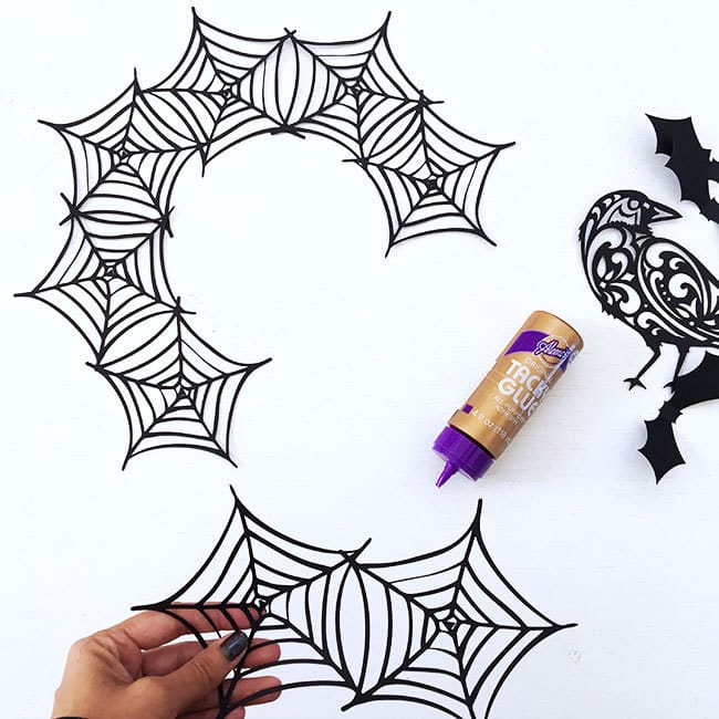 Glue each spiderweb together until you create a circle of webs