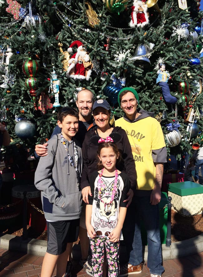 Happy at Disneyland in front of the Christmas Tree