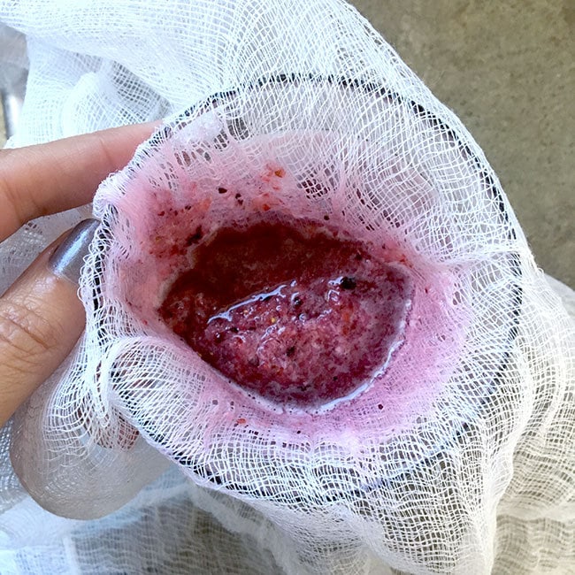 Strain berry seeds with cheesecloth