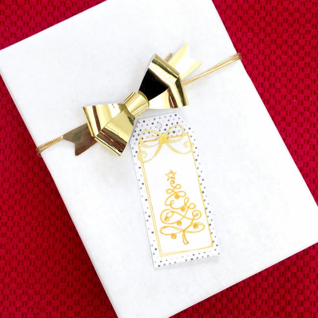 Add gold accents to pretty white gifts - gift tag made with Cricut