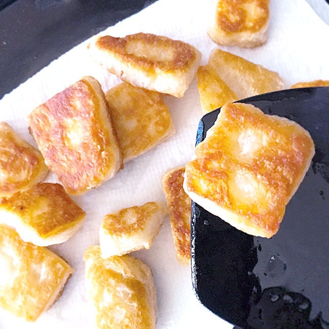 Cooking beignet bites in a skillet