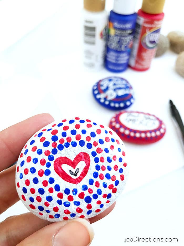 Using a small paint brush, add decorative painted designs to your rocks