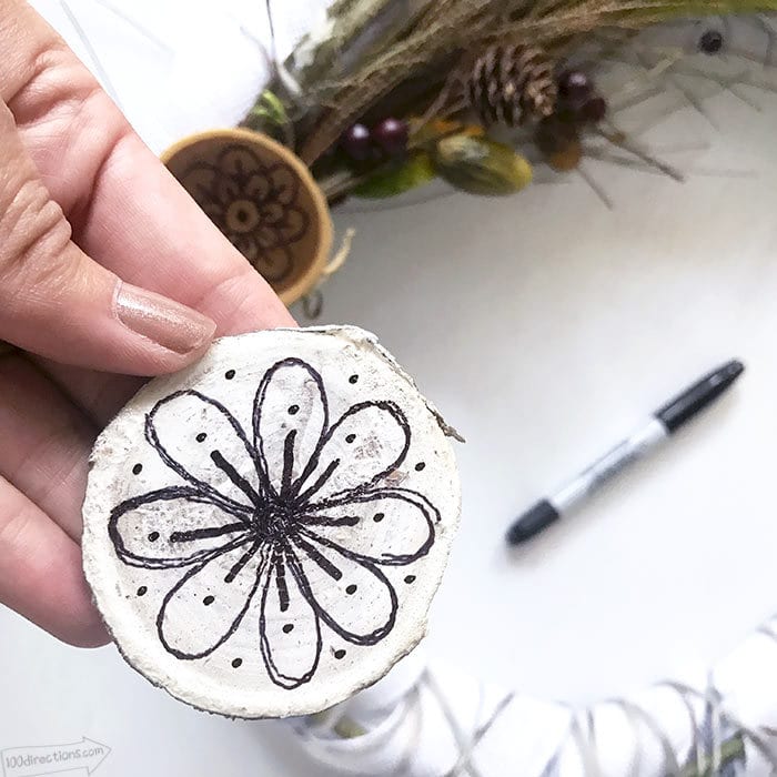 Add hand drawn wood slices to the wreath