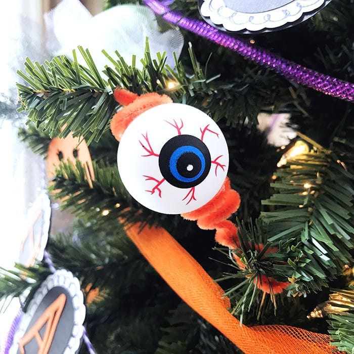 Add chenille stems to plastic eyeballs to make creepy eyeball ornaments