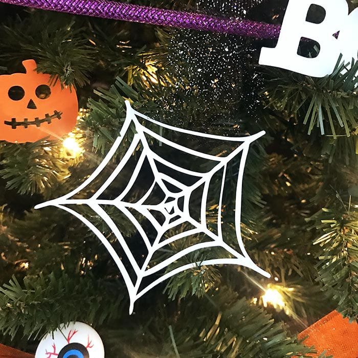 Paper spiderweb cutouts you can make yourself to add to your Halloween tree - designed by Jen Goode