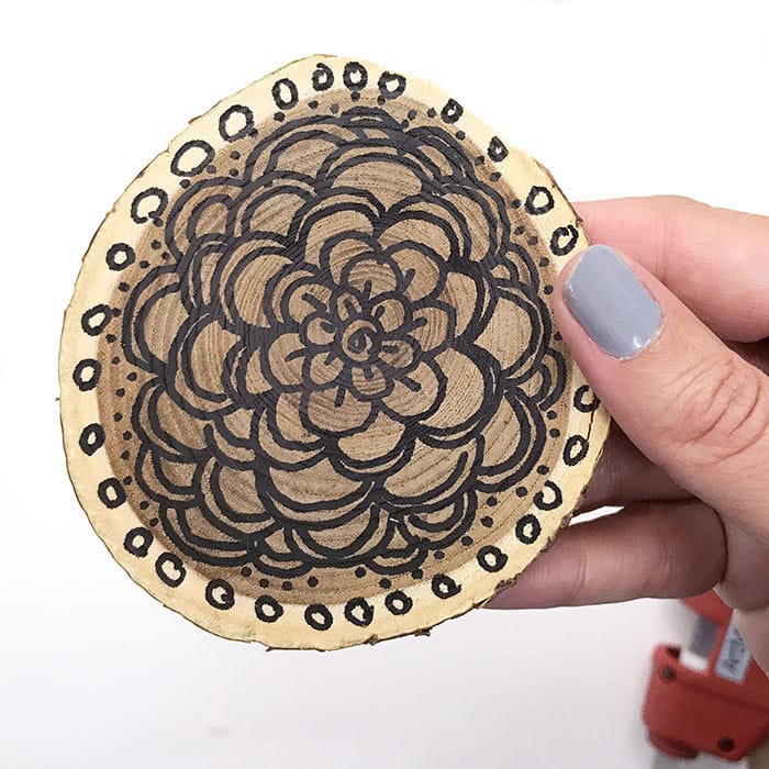 Draw flowers on wood slices for a neat art look