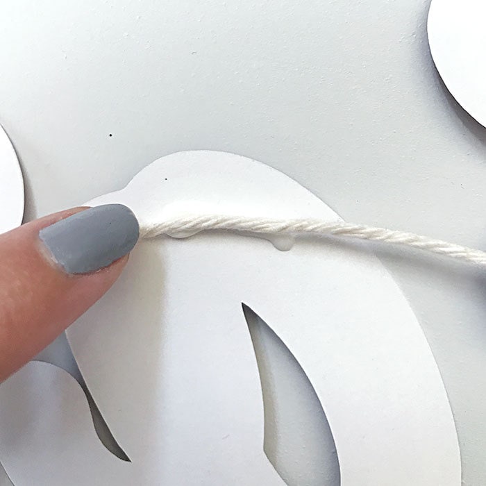 Attach twine with glue to back of each letter