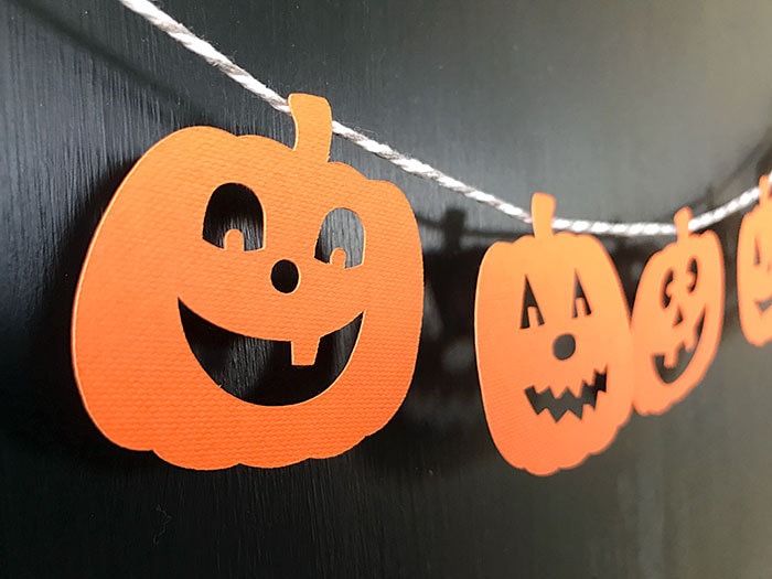 String cute pumpkin faces together to make easy Halloween garland