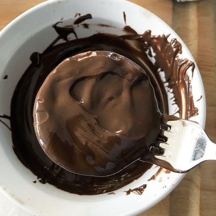 Tap fork to level out chocolate and remove excess