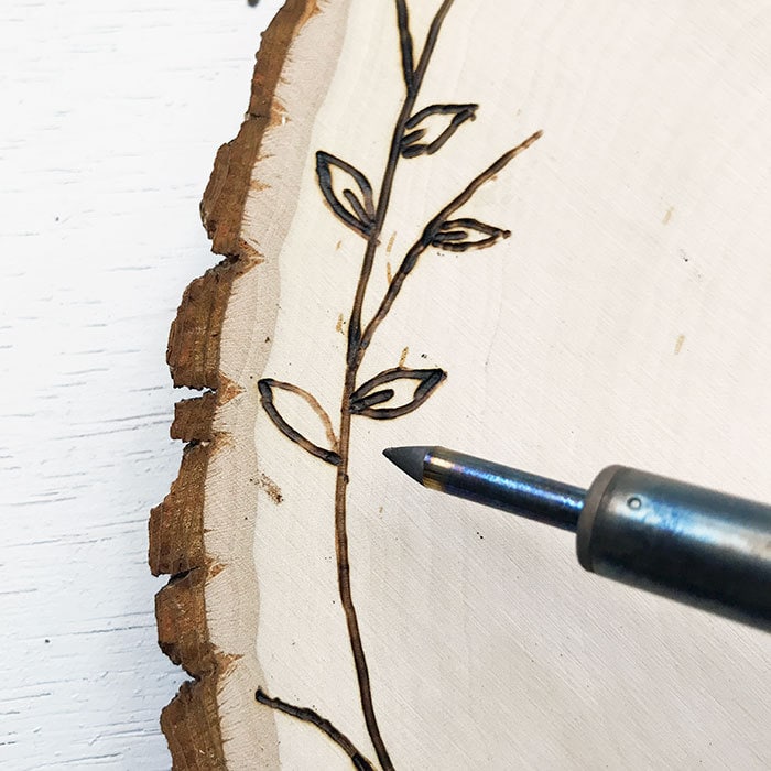 Draw design with the wood burning tool