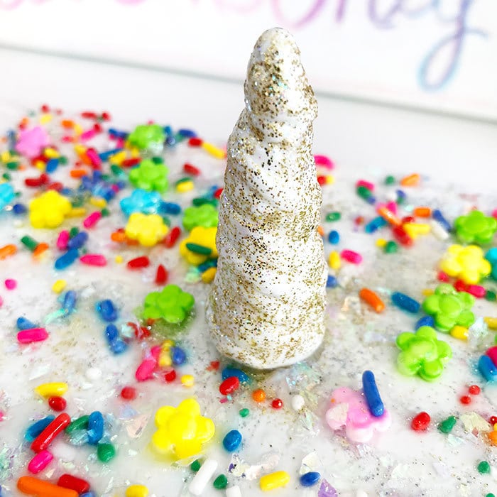 Finished unicorn horn made from clay, paint and finished with gold glitter