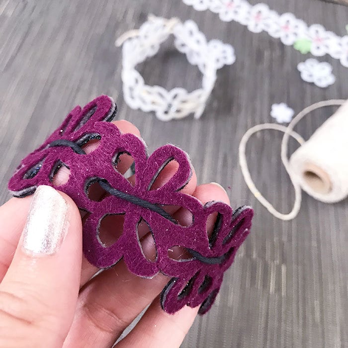 Thread twine through the flowers to create a bracelet - Cricut project designed by Jen Goode