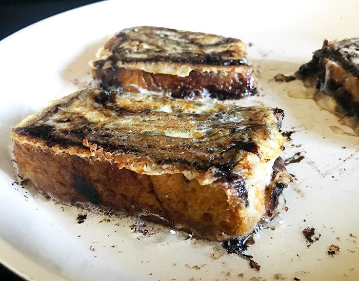 Cook Babka french toast in a skillet with coconut oil