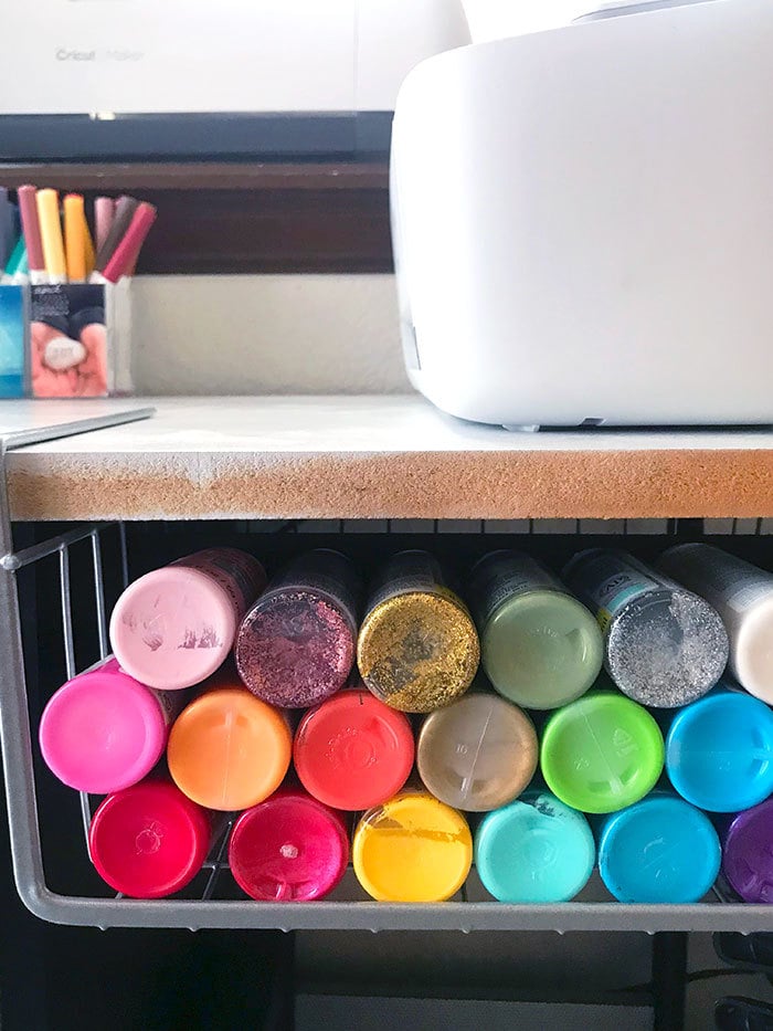 Organize paint by color and store in small hanging basket