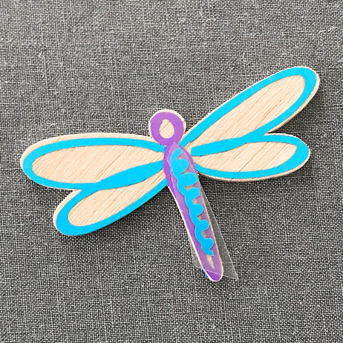 Final vinyl layer applied to the dragonfly art