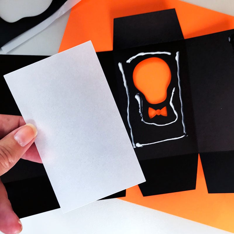 Assemble the Halloween treat bag with glue.