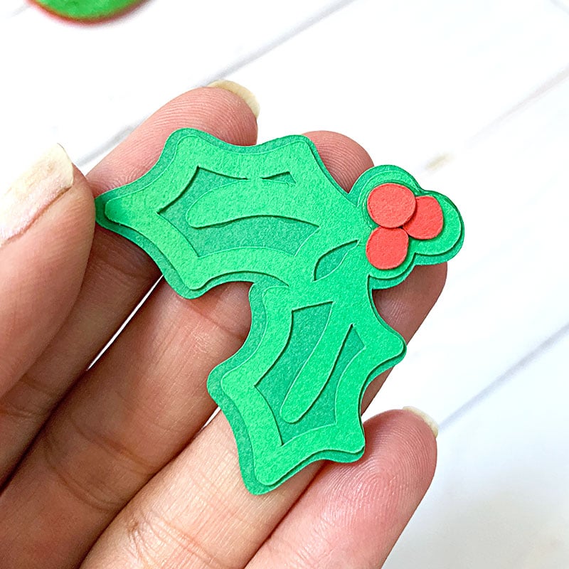 Use your Cricut machine to cut cute mini holly for cupcake decorations