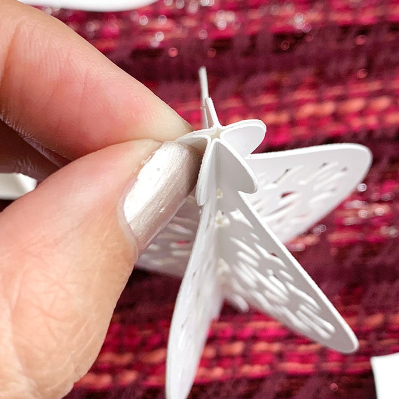 Glue layers together to create a 3D paper Christmas ornament