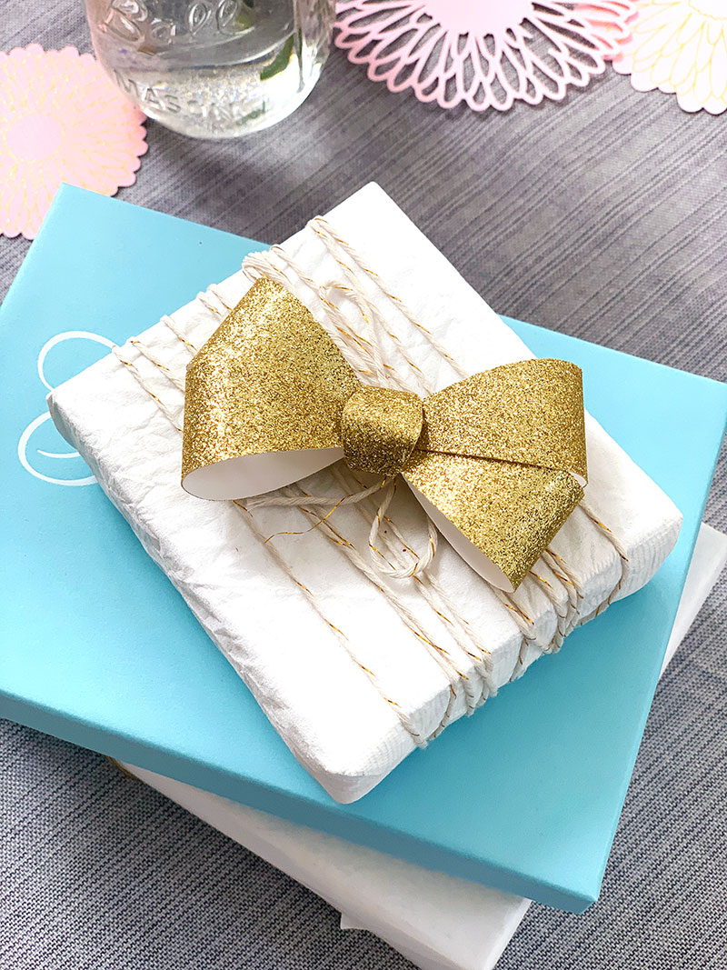 Wrap gift box with twine and add a handmade bow