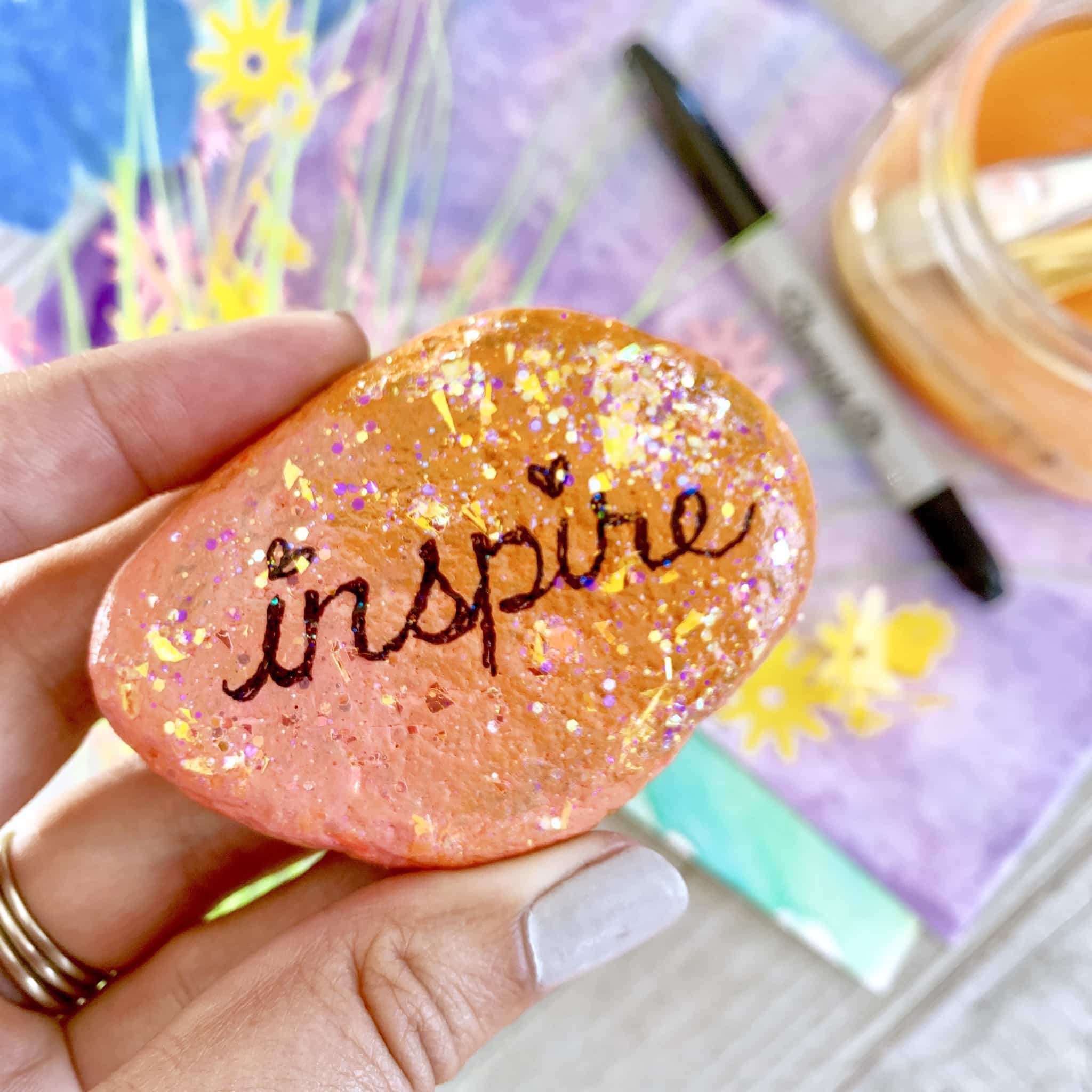  Inspire - glitter word art painted rock by Jen Goode